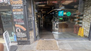 Glass door. Push metal handle on right to open. Built-in ramp at foot of door.