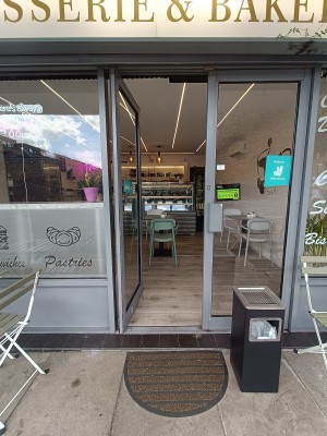 Glass doors with grey, metal frames. Push from middle to open.