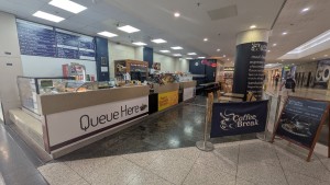 Open entrance between counter and banner.