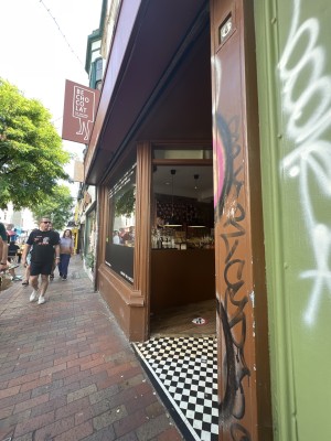 Brown building with the main entrance with checkered floor