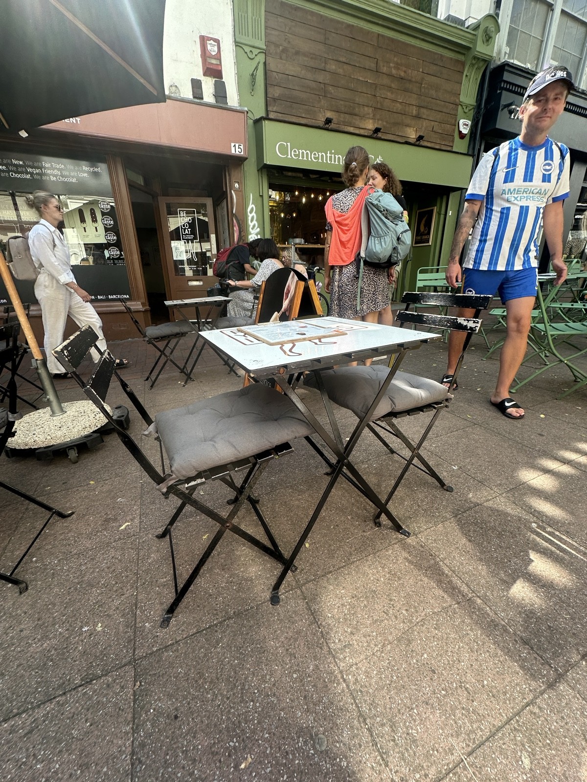 Set of 2 chairs with one table on slightly slanted table.
