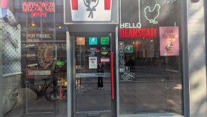 Glass door. Push red handle on left to open.