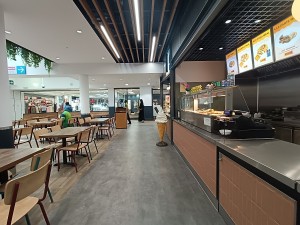 From counter, facing left. Counter along right. Tables and chairs spread on left.