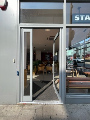 Facing glass door ahead. Push handle on left to open.