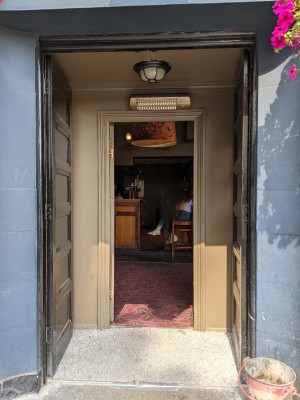 Wooden doors with concrete frame. Push from centre to open.
