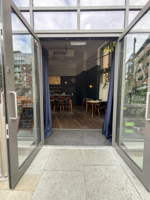 Glass doors pull to open. Metal bump after entrance.