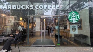 Glass doors with silver handle in middle. Push to open.