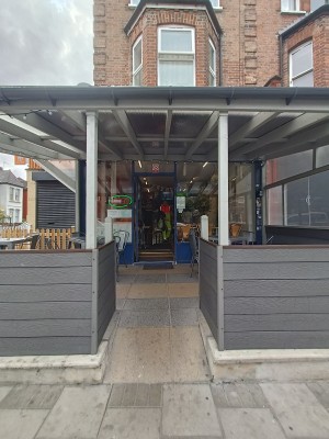 From street, facing venue. Archway ahead.