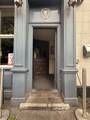 Blue wooden door. Push to open. Followed by brown wooden door. Metal handle on right. Pull to open.