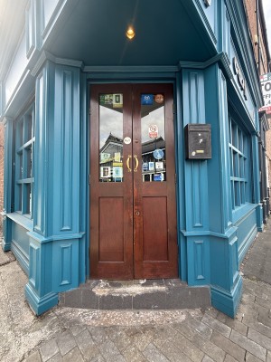 Wooden doors with metal handles on left and right. Pull to open.