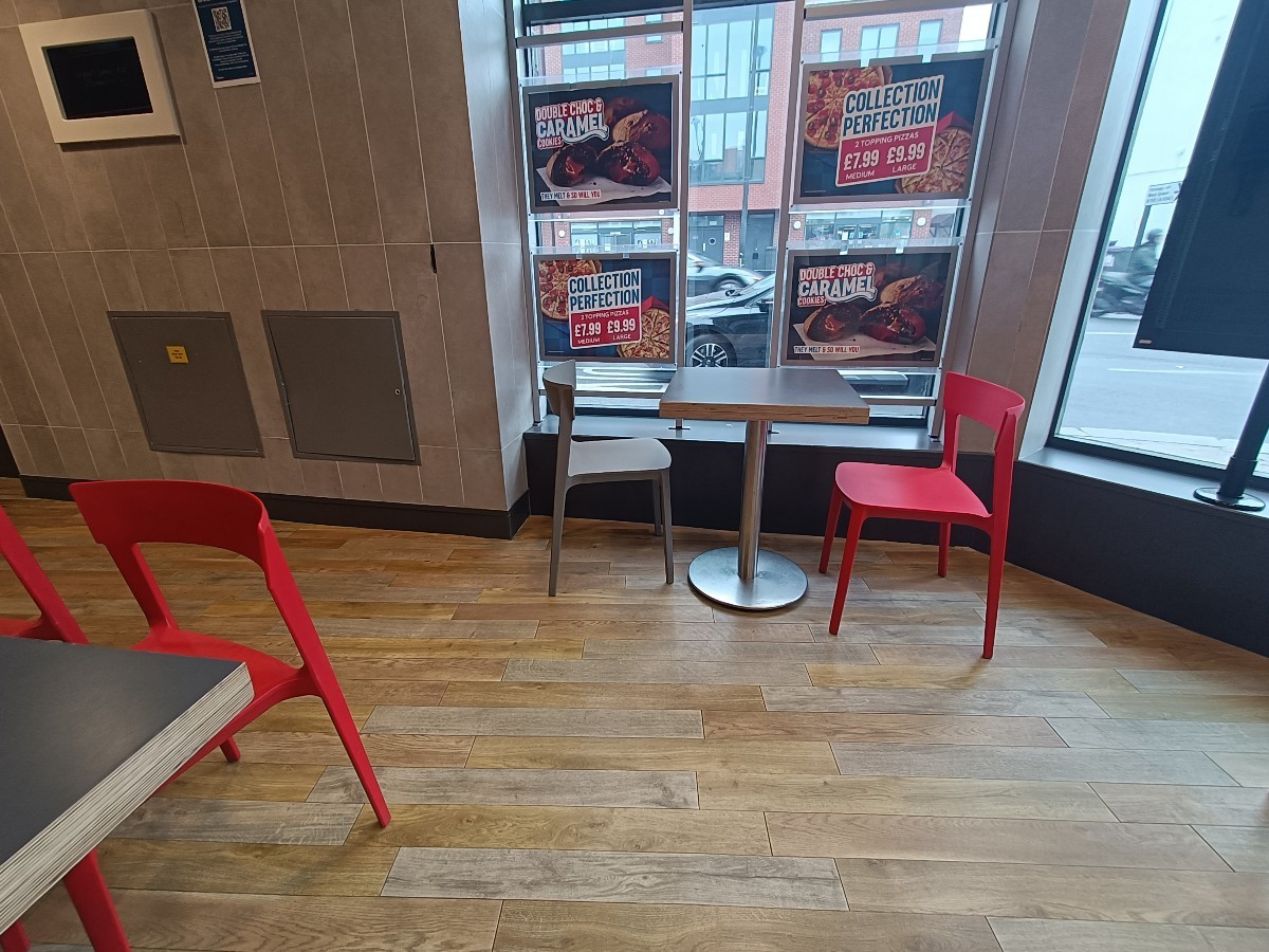 From end of wall divider, facing straight. Table and chairs at back and on left.