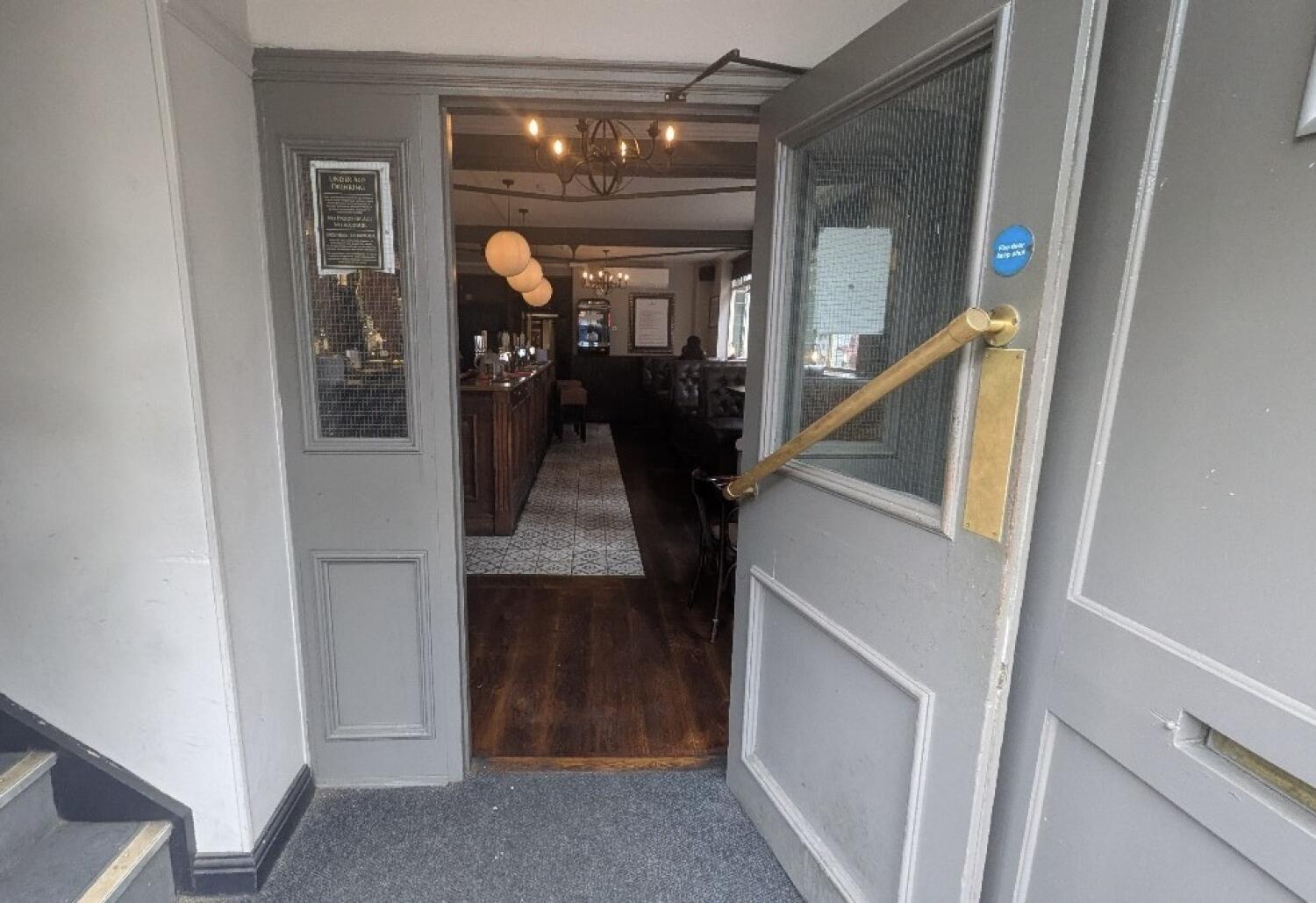 From entrance facing straight. Second door ahead. Pull handle on left to open.