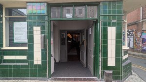 Grey wooden doors. Push center to open. Glass doors afterwards