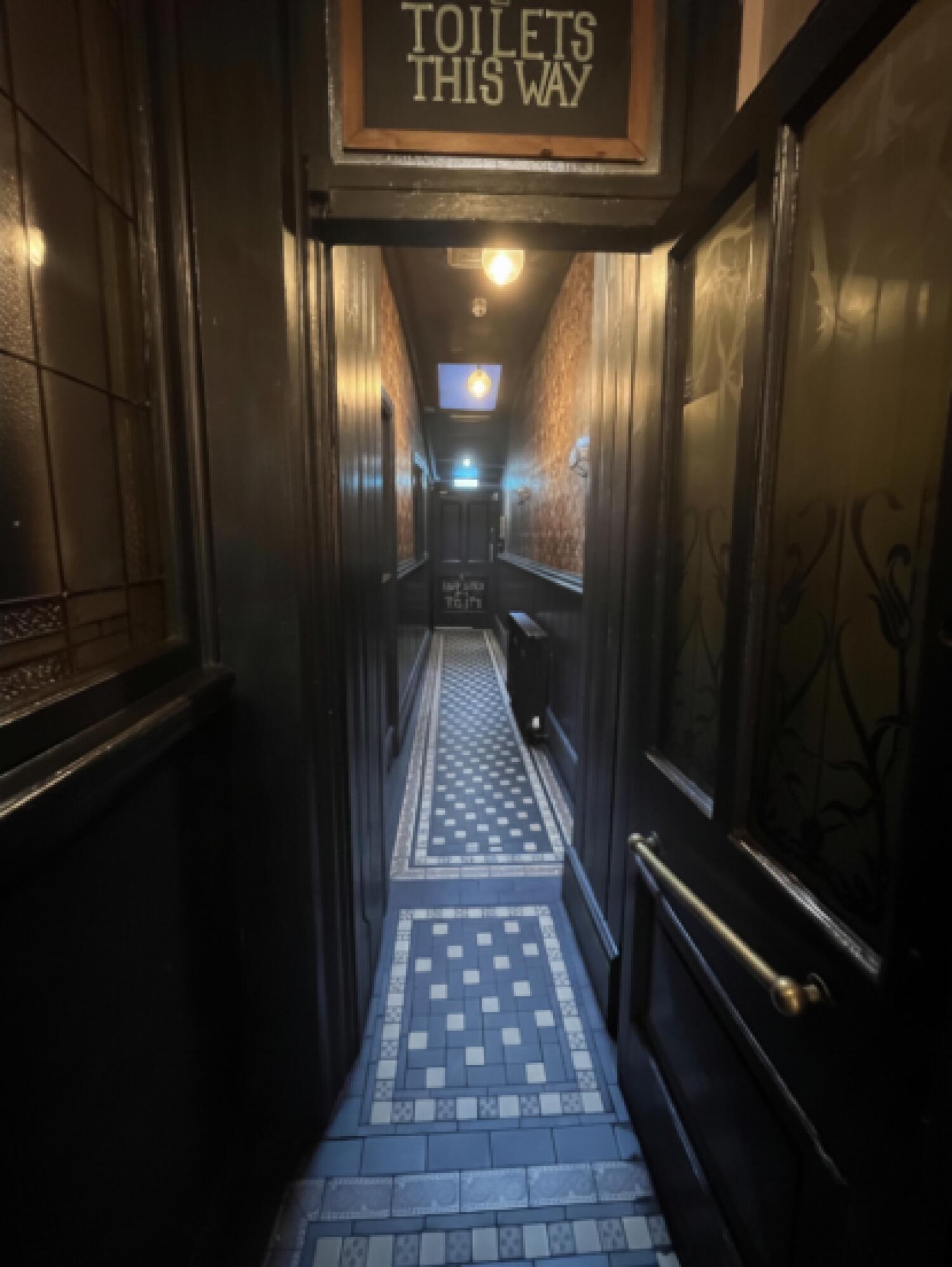 From end of path facing straight. Wooden door ahead. Pull from left to open.