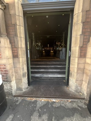One step up to black framed archway ahead.