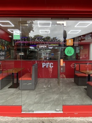 Glass door with metal handle on right, push to open.