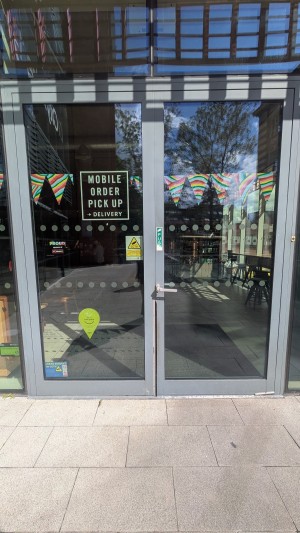 Glass doors with metal frame. Push handle on center to open