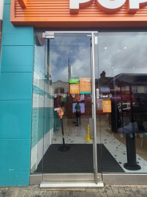 Glass door. Push handle on right to open.