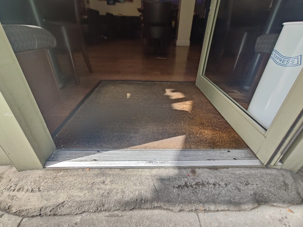 Bump at foot of door. Doormat after.