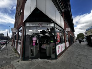 From sidewalk facing venue, entrance with glass double doors.