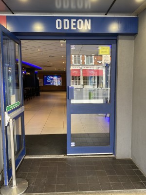 Blue framed glass double door. Pull from the blue metal handle in centre to open.