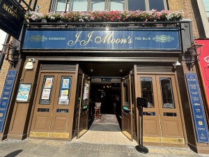 From sidewalk facing venue. Entrance in the centre.