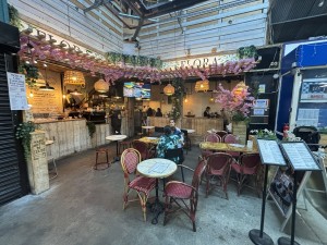 From inside the market facing the venue. Entrance to the counter and seating are on the left side.