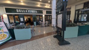 From path facing venue planters to both sides. Path to entrance in center. Menu board to right.