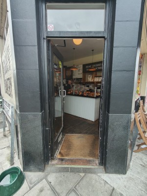 Black framed glass door. Push silver handle on right to open.
