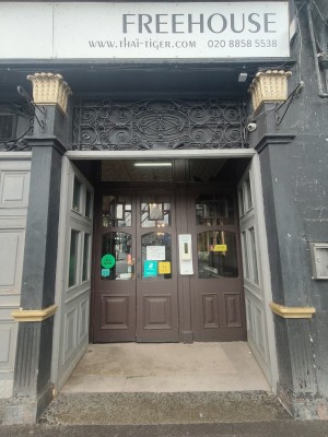 Preceding grey archway to entrance doors.