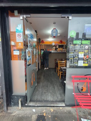Glass door. Push silver handle on right to open.