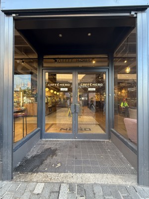 Archway followed by glass doors. Pull on right.