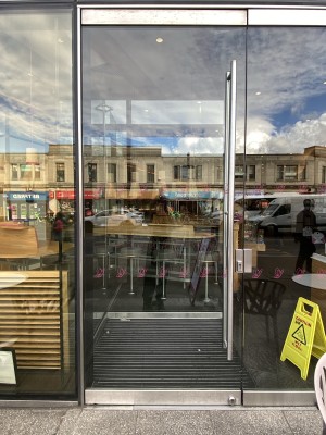Sliver framed glass door. Pull or push the handle on right to open.
