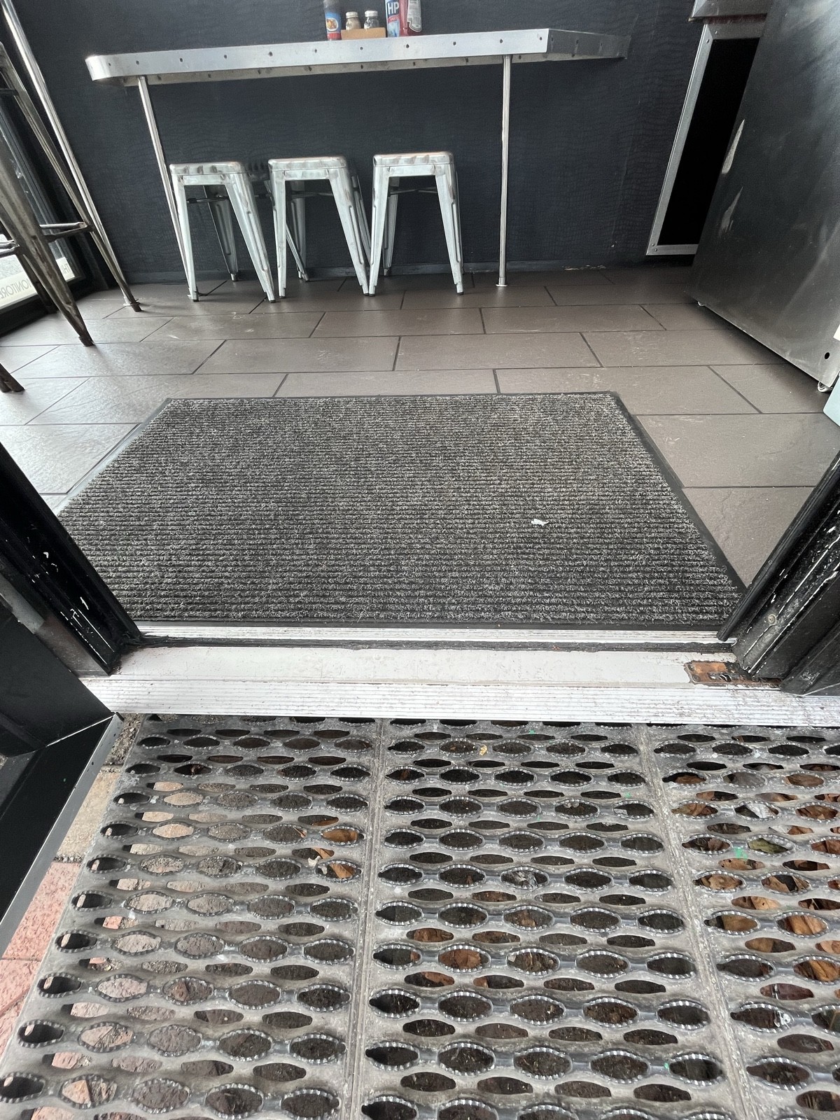 Ramp up. Followed by a metal bump and door mat.