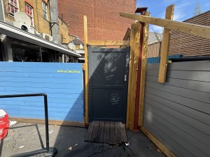From back street facing ahead. Door to enter the venue’s outdoor backspace seating ahead.