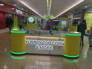 Counter ahead in the middle of pathway in mall.
