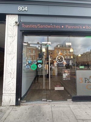 Glass doors with silver handles in middle. Push from center to open.