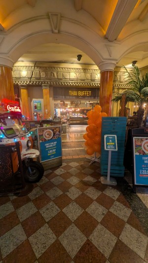 From street facing venue. Welcome desk to left. Information boards on right. Path to entrance in center