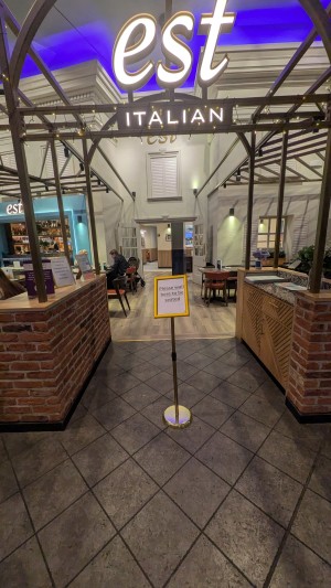 From street facing venue. Waiting desk in center. Path to door ahead.