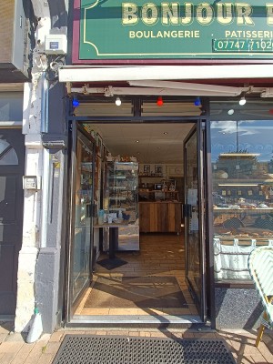 Glass doors with black, metal frames. Push from middle to open.