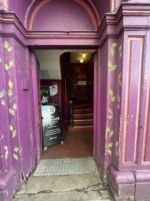 Purple double door with handle in centre. Push to open.