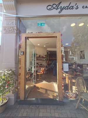 Glass door with silver handle on right. Push to open.