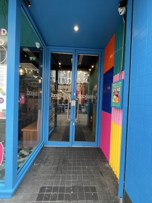 Archway with a blue frame. Door at the back.