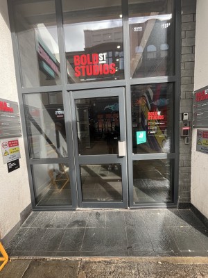 Glass door with metal handle on right. Pull to open.
