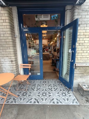 Blue framed glass doors ahead. Pull silver handle in centre to open.