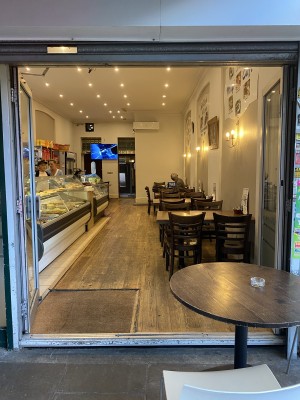 Silver-framed glass doors. Push left door from centre to open.