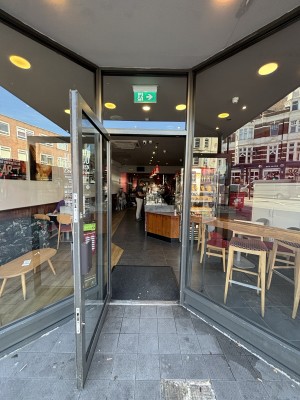 Grey framed glass door ahead. Pull door to open outwards.