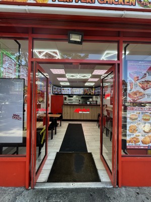 Red framed double glass doors ahead. Push doors to open inward.