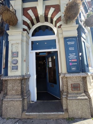 From street facing straight. Archway in front.