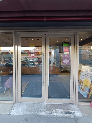 Glass doors with silver metal frames. Push from middle to open.
